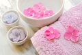 Flowers in a water bowl with a candle and a towel