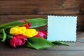 Flowers and a welcome card on dark wooden background. Concept of