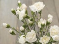 Flowers white carnations on a wooden table.