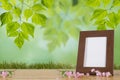 Flowers and white photo frame on wooden table