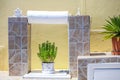 Flowers in white pots in cozy hotel in Santorini