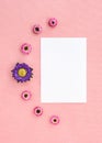 Flowers and white sheet of paper on pink canvas Royalty Free Stock Photo