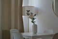 Flowers in a white vase on the table. Interior design