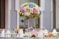 Flowers, wine glasses, napkins and salad on the table.