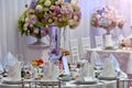 Flowers, wine glasses, napkins and salad on the table.