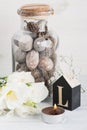 Flowers and wooden letter L on white table Royalty Free Stock Photo