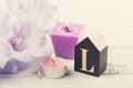 Flowers and wooden letter L on white table Royalty Free Stock Photo