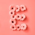 Flowery letter E made from gerbera on a color background of the year 2019 Living Coral Pantone. Part of the word LOVE Royalty Free Stock Photo