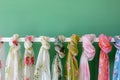 flowery scarves displayed on a white rack against a green backdrop Royalty Free Stock Photo