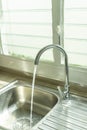 Flowing , clean, fresh tap water to the kitchen sink. Royalty Free Stock Photo