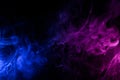 Flowing clouds of colorful swirling blue and pink smoke abstract background