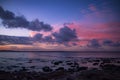 Flowing clouds in sunset sky above ocean Royalty Free Stock Photo