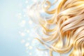 Flowing golden curls cascade elegantly across a soft blue backdrop, enhanced by sparkling light that adds a touch of