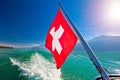 Flowing on idyllic Swiss lake Lucerne boat flag view Royalty Free Stock Photo