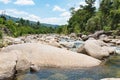 Flowing mountain stream with transparent water and stones Royalty Free Stock Photo