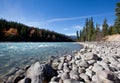 A flowing river with mountains in the distance Royalty Free Stock Photo