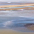 Flowing sea water on sand at low tide in the bay of Mont Saint-Michel Royalty Free Stock Photo