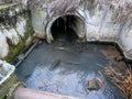 Flowing sewage water trough concrete tank, the water is transported to a small river Royalty Free Stock Photo