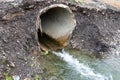 Flowing waste water trough concrete pipe polluting the environment Royalty Free Stock Photo