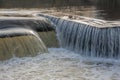Flowing water cascading over a weir on yorkshire river Royalty Free Stock Photo