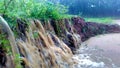 Flowing water causing soil erosion during heavy rain and flood Royalty Free Stock Photo