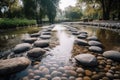 flowing water over smooth pebbles and stepping stones in the park Royalty Free Stock Photo