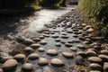 flowing water over smooth pebbles and stepping stones in the park Royalty Free Stock Photo