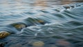 Flowing water over smooth rocks creates gentle ripples and small waves Royalty Free Stock Photo
