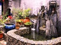 Flowing water, stones, fountain, vases, plants, bird cage, peace and relax in China