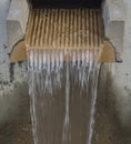 Flowing water stream from concrete trough modern fountain