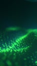 Flowing wave of glowing green digital particles on a dark background Royalty Free Stock Photo