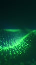 Flowing wave of glowing green digital particles on a dark background Royalty Free Stock Photo