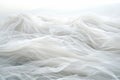 Flowing White Tulle Fabric Texture With Waves, Abstract Background Of Delicate Transparent Material Royalty Free Stock Photo