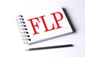 FLP word on notebook on white background Royalty Free Stock Photo