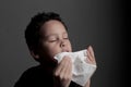 The flu child blowing nose after catching a cold with background stock photo Royalty Free Stock Photo