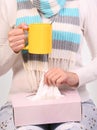 Flu cold. Sick woman with cup of tea and tissue box