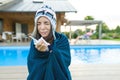 Flu, colds in the summer. Girl in a knitted hat with plaid with handkerchief sneezes, wipes her nose. Background nature, pool, gir Royalty Free Stock Photo