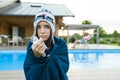 Flu, colds in the summer. Girl in a knitted hat with plaid with handkerchief sneezes, wipes her nose. Background nature, pool, gir Royalty Free Stock Photo