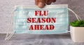 FLU SEASON AHEAD inscription on a medical mask Royalty Free Stock Photo