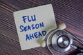 Flu Season Ahead write on sticky notes isolated on Wooden Table Royalty Free Stock Photo