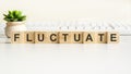 fluctuate word made with wooden blocks, concept Royalty Free Stock Photo