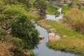 fluent river with rocks, vegetation, fisherman and boat in africa. Lubango. Angola.