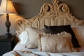 fluffed luxury bedding on a bed with decorative headrest
