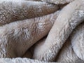 Fluffy Beige Bedcover Fabric Texture with heavy Folds and Crests Royalty Free Stock Photo