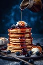 Fluffy Blueberry Pancakes with Syrup and Butter on Dark Blue Plate Royalty Free Stock Photo