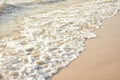 Waves rushing to shore on soft fine sand beach. Royalty Free Stock Photo