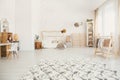 Fluffy carpet in white kid bedroom interior with house-shaped be