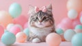 Fluffy Cat with Stripes and a Bow Surrounded by Soft Pastel Bubbles and Balls Royalty Free Stock Photo