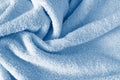 Fluffy classic blue towel background, close-up. Gentle baby pastel fabric with waves and folds. Folded tender light blue towel Royalty Free Stock Photo