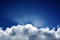 Fluffy clouds blue sky crepuscular rays